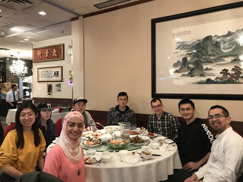 Group members around a round table in a restaurant at a winter dinner in 2018