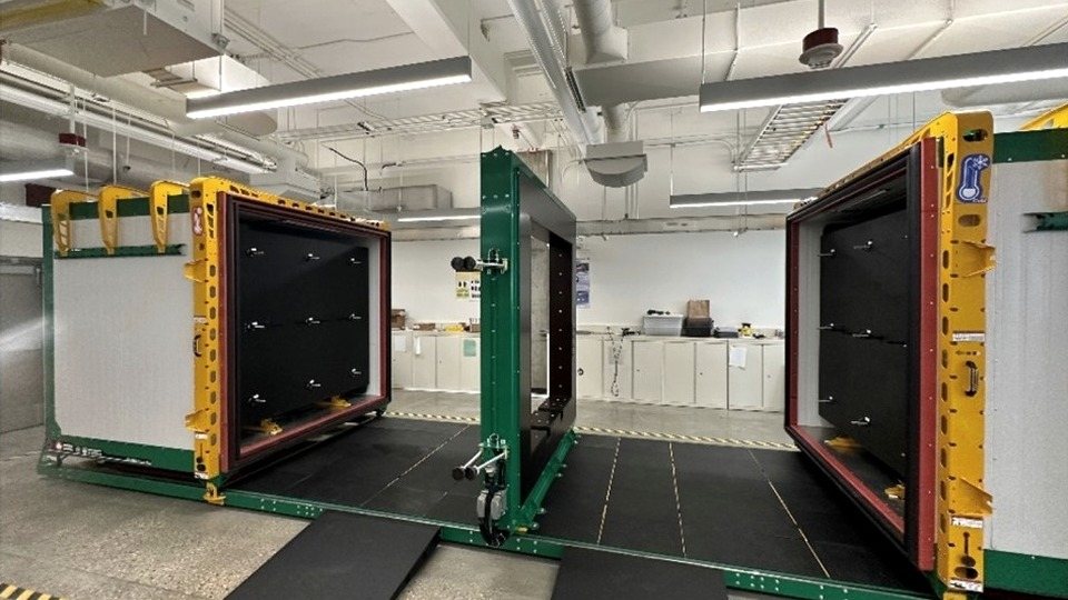 The STEEE chamber in the IDOBE lab: two climate chambers open on a shared rail system with the test frame standing between them.